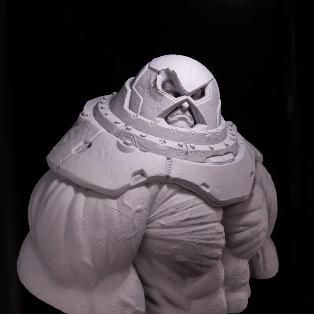 Primed grey Juggernaut bust under hard top-down light on the helmet